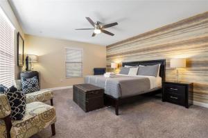 a bedroom with a bed and a ceiling fan at Experience Solterra: Pool, Spa, Game Room & Lazy River in Davenport