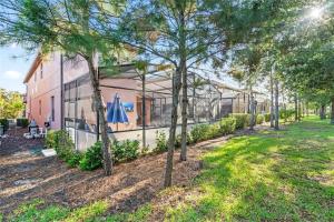 a building with trees in front of it at Experience Solterra: Pool, Spa, Game Room & Lazy River in Davenport