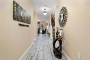 a hallway of a home with a tile floor at Experience Solterra: Pool, Spa, Game Room & Lazy River in Davenport