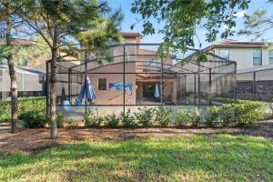 a glass house in front of a house at Experience Solterra: Pool, Spa, Game Room & Lazy River in Davenport