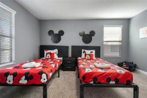 a bedroom with two beds with hello kitty pillows at Experience Solterra: Pool, Spa, Game Room & Lazy River in Davenport