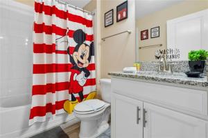 a bathroom with a red and white shower curtain at Experience Solterra: Pool, Spa, Game Room & Lazy River in Davenport