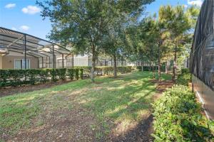 a yard with trees in front of a building at Experience Solterra: Pool, Spa, Game Room & Lazy River in Davenport