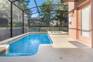a swimming pool in the backyard of a house at Experience Solterra: Pool, Spa, Game Room & Lazy River in Davenport