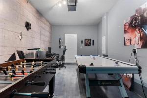 a billiard room with several tables and billos at Experience Solterra: Pool, Spa, Game Room & Lazy River in Davenport