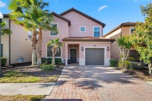 a house with palm trees and a driveway at Experience Solterra: Pool, Spa, Game Room & Lazy River in Davenport