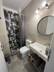 a bathroom with a toilet and a sink and a mirror at 11 Diamond Drive, Luxury Bright & Quiet City Center Loft, Easy Access in Kavála +31 photos