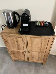 a coffee maker on top of a wooden cabinet at 11 Diamond Drive, Luxury Bright & Quiet City Center Loft, Easy Access in Kavála