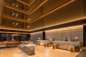 a large lobby with a large rock in the middle at Hilton Kyoto in Kyoto