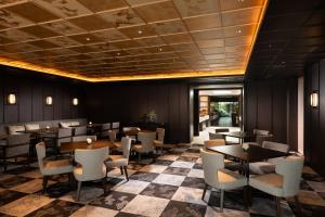 a restaurant with tables and chairs in a room at Hilton Kyoto in Kyoto