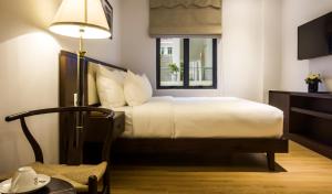 Giường trong phòng chung tại Di lusso Boutique Hotel Riverside Danang