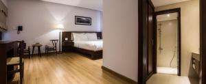 Giường trong phòng chung tại Di lusso Boutique Hotel Riverside Danang