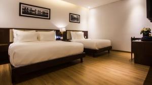Giường trong phòng chung tại Di lusso Boutique Hotel Riverside Danang