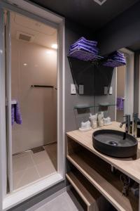 a bathroom with a sink and a shower at Niseko Grand Hotel in Niseko