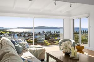 a living room with a couch and a large window at The View, Albany Holiday House in Albany