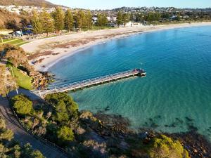 an aerial view of a pier next to a beach at The View, Albany Holiday House in Albany