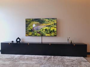 a painting of a bridge on a wall at Contemporary apartment at Lemac in Nairobi