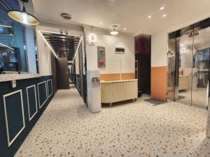 a room with a refrigerator in the middle of a room at Dongdaemun Karrot Hostel in Seoul