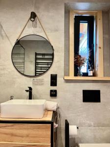 a bathroom with a sink and a mirror at Miło Zakopane in Zakopane +61 photos