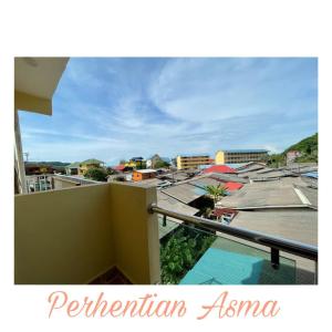 a view of a city from the balcony of a building at Perhentian Asma in Kampung Kuala Besut +6 photos