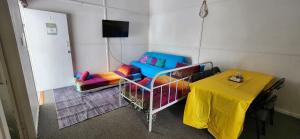 a room with a table and a yellow table cloth at Golden Mount Rest Townside in Mount Morgan