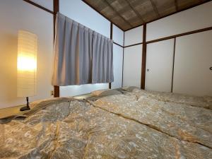 a bedroom with a large bed and a window at Slowhouse HAYAMA in Hayama +30 photos