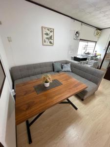 a living room with a couch and a wooden table at Slowhouse HAYAMA in Hayama