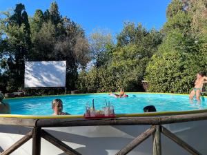 a group of people in a swimming pool at Boschetto Natural Village in Monte San Giusto