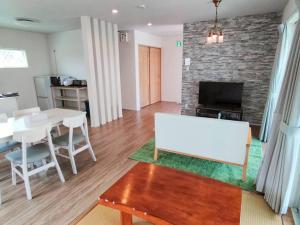 a living room with a white table and a fireplace at Private Villa Espacio Onna in Inbu