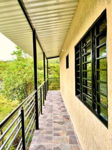 a walkway leading down to a building with windows at El Diamante - Finca Privada con Piscina Barbosa in Barbosa