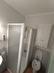 une petite salle de bain avec toilettes et lavabo dans l'établissement Habitación Cama Grande doble 150 x 190 Smart TV, à Novelda