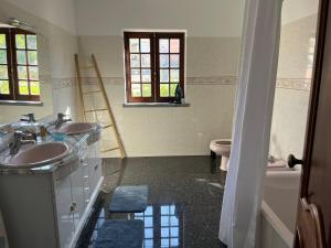 a bathroom with two sinks and a tub and a toilet at Brisa Bright Retreat Near the Beach! in Lourinhã +9 photos