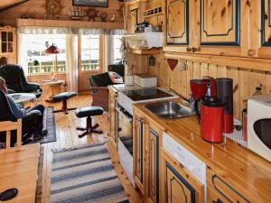 a kitchen with wooden cabinets and a counter top at 6 person holiday home in BORKENES-By Traum in Harstad +25 photos