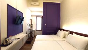Ένα ή περισσότερα κρεβάτια σε δωμάτιο στο Riche Heritage Hotel