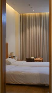 Voodi või voodid majutusasutuse Taihua Wutong Hotel toas