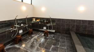 a bathroom with two sinks and two toilets in it at EN Takeda Castle Town Hotel in Asago