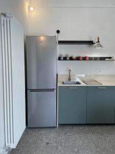 a kitchen with a white refrigerator and a sink at Casa Vacanze La Quercia in San Vito Chietino