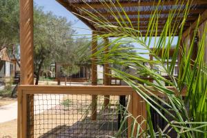 a wooden fence with a plant next to it at TAIGA Almeria Playa in Palomares