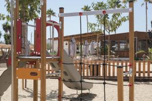 a playground with a slide in the sand at TAIGA Almeria Playa in Palomares