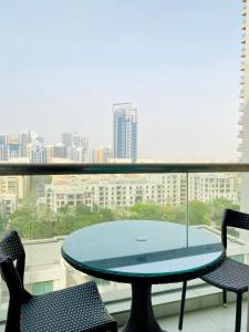 a table in a balcony with a view of a city at Greens in Dubai