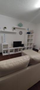 a living room with a couch and a flat screen tv at Casa da Tia in Ferrel +27 photos