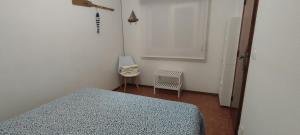 a bedroom with a bed and a chair in it at Casa da Tia in Ferrel