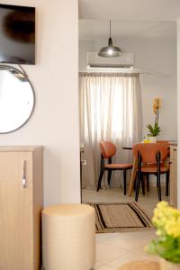 a living room with a table and chairs at Eva's paradise Syros in Ermoupoli