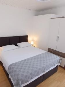 a bedroom with a large bed with white sheets at Apartmani Šprljan in Vodice +37 photos