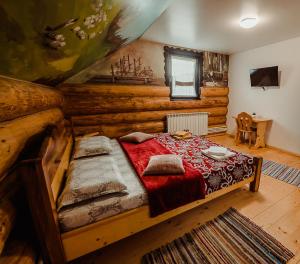 a bedroom with a bed in a wooden room at Casa din Valea Bucovinei in Valea Moldovei +14 photos