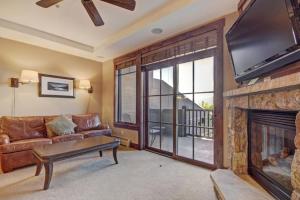 a living room with a couch and a fireplace at Crystal Peak Lodge 1 Bedroom Ski In, Ski Out Slopeside Condo At The Base Of Peak 7 in Breckenridge