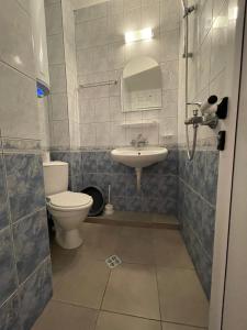 a bathroom with a toilet and a sink at Alatoni Beach Hotel in Sozopol
