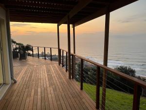 a porch of a house with a view of the ocean at The Windsock in Ballito