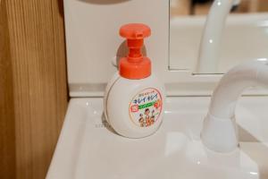 a bottle of dish soap sitting on top of a sink at Value Osaka Tengachaya Namba Condo in Osaka
