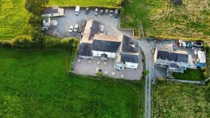an aerial view of a house with a yard at Ty Dderw in Moelfre
